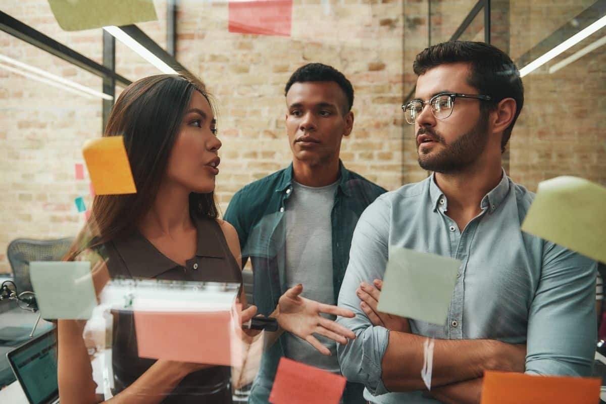 3 people talking with sticky notes