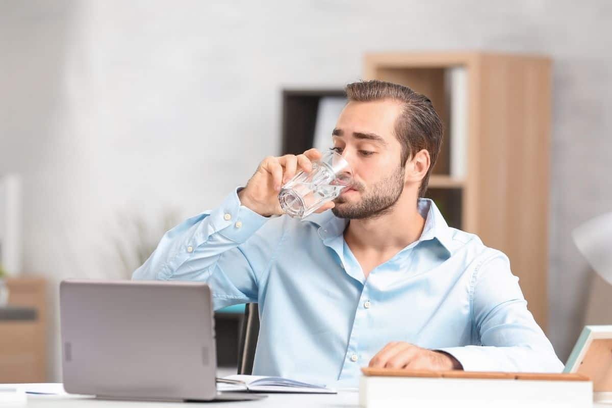 a man drinking water at work