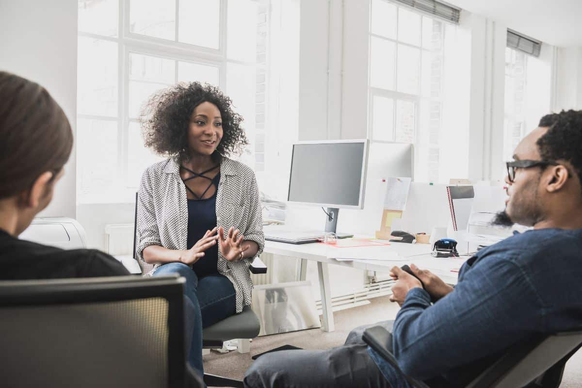 a woman talking in an assertive way with colleagues