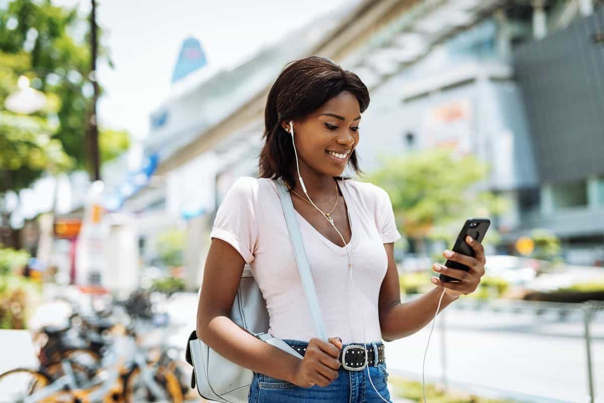 woman listening to a podcast outside