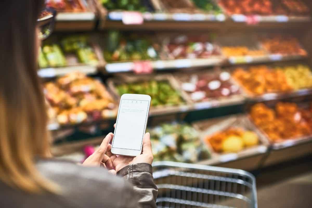 woman using a grocery list app