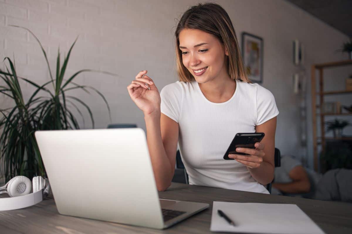 happy woman with smartphone in hand