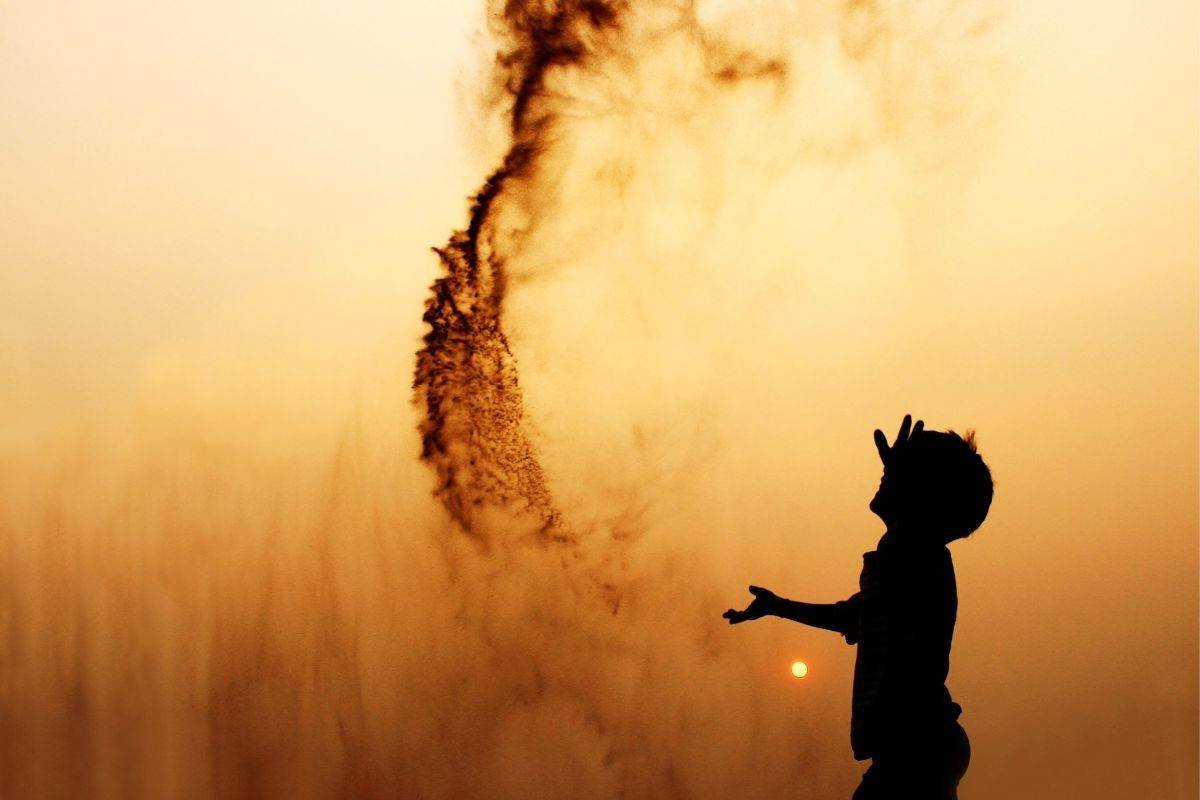 person throwing sand into the air