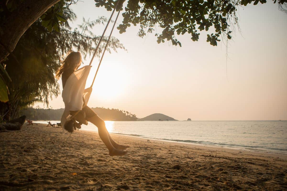 woman swinging on the beach