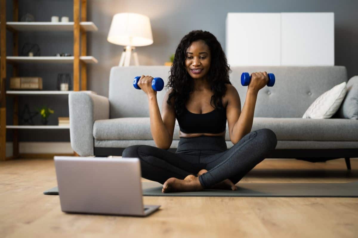 woman using barbells at home