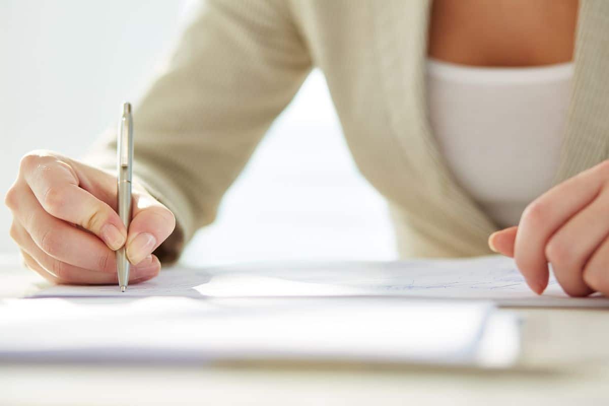 woman writing a letter with a pen